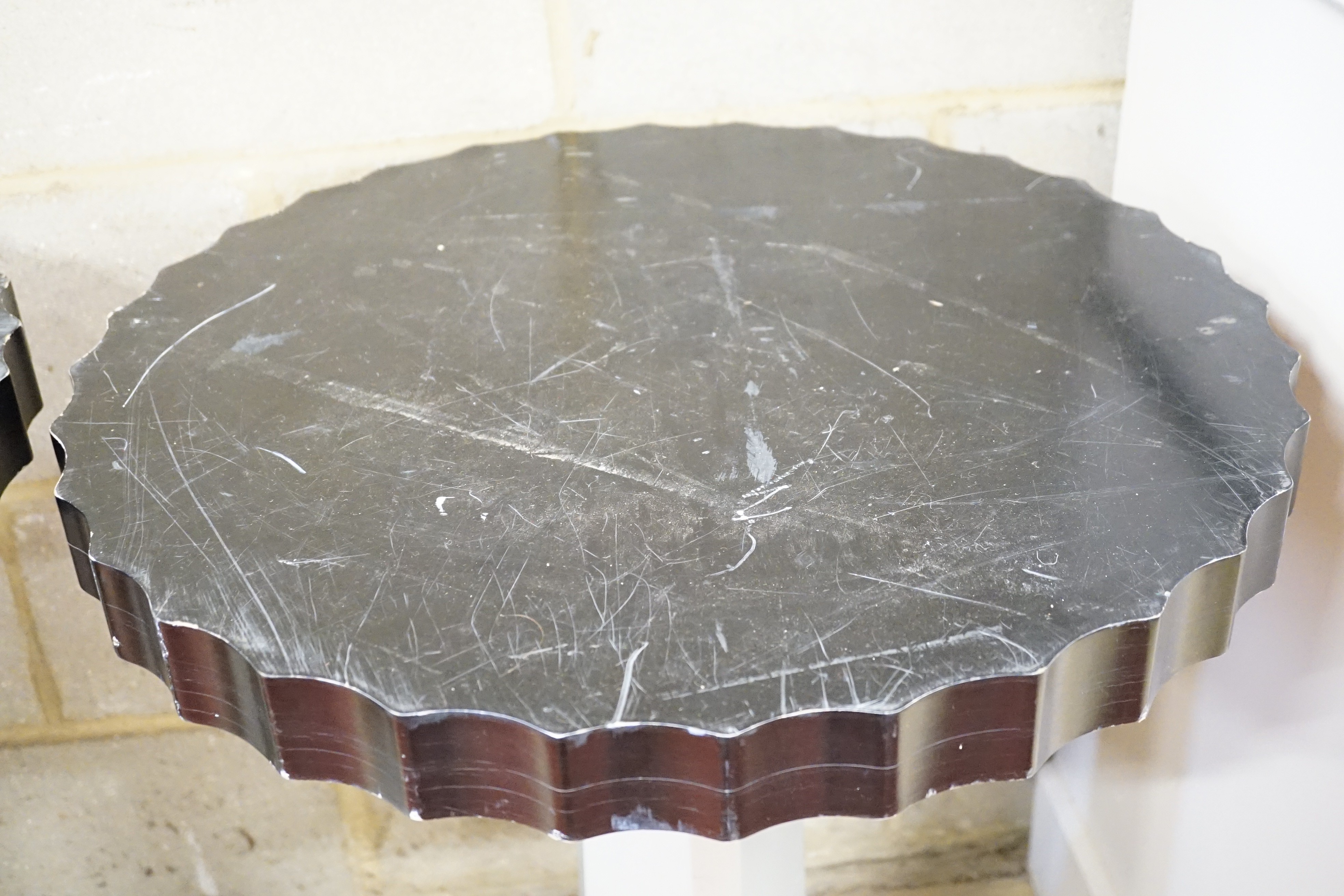 A pair of Art Deco ebonised and silvered wood occasional tables, diameter 60cm, height 71cm
